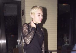 Miley Cyrus boots and black pantyhose